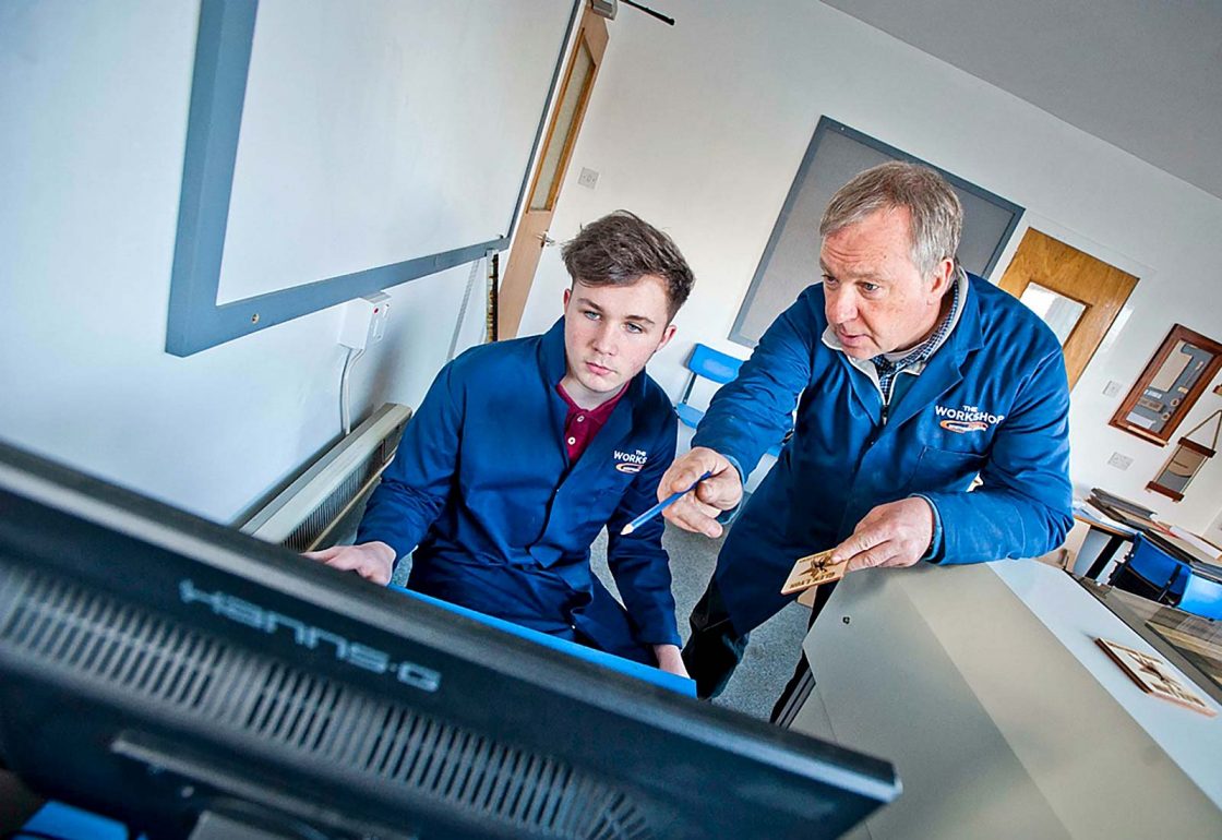 An image of a young male with teacher working for the Aberfeldy Community Workshop a charity supported by the Ellis Campbell Foundation, helping disadvantaged young people in Hampshire, London and Perthshire