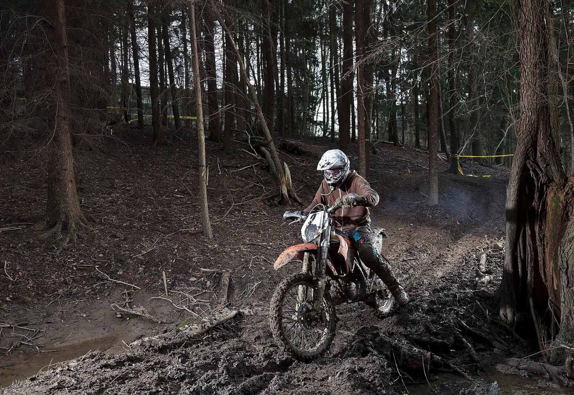 An image of a young boy on a motorcycle in the woods taking part in the Archway project, a motorcycle education and youth centre programme supported by the Ellis Campbell Foundation, helping disadvantaged young people in Hampshire, London and Perthshire