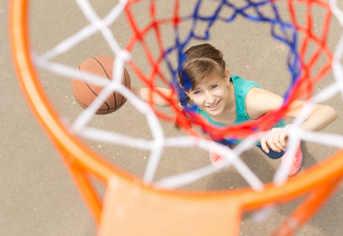 An image of a smiling teenager taking part in the Kick London Sports Programme, a charity supported by the Ellis Campbell Foundation, helping disadvantaged young people in Hampshire, London and Perthshire