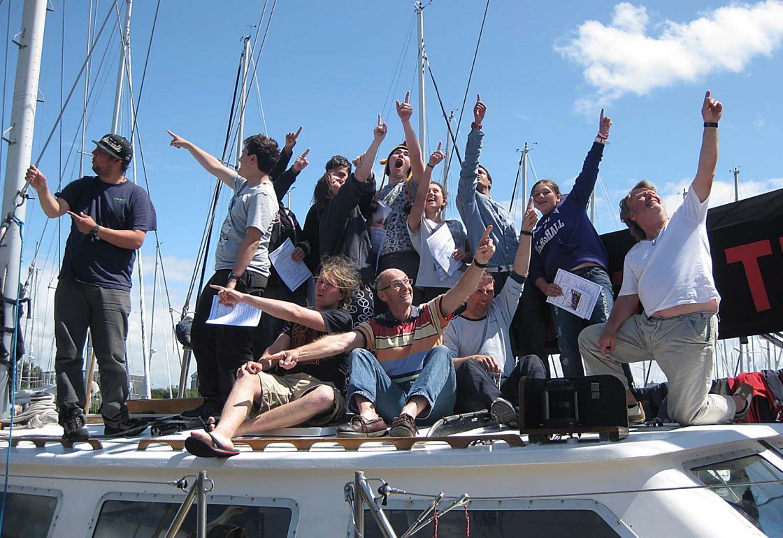 An image of a group of young people sat on the roof of a boat part of Ocean Youth Trust South a charity supported by the Ellis Campbell Foundation, helping disadvantaged young people in Hampshire, London and Perthshire