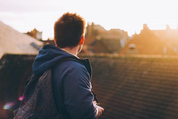 A colour photo of a young man overlooking rooftops representing the Spark Inside coaching programme, a charity supported by the Ellis Campbell Foundation, helping disadvantaged young people in Hampshire, London and Perthshire