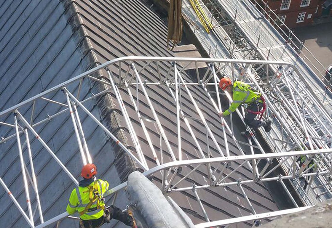 An image of Winchester Cathedral renovations Birth of a Nation project, with men scaling protective scaffolding, a charity supported by the Ellis Campbell Foundation, helping disadvantaged young people in Hampshire, London and Perthshire