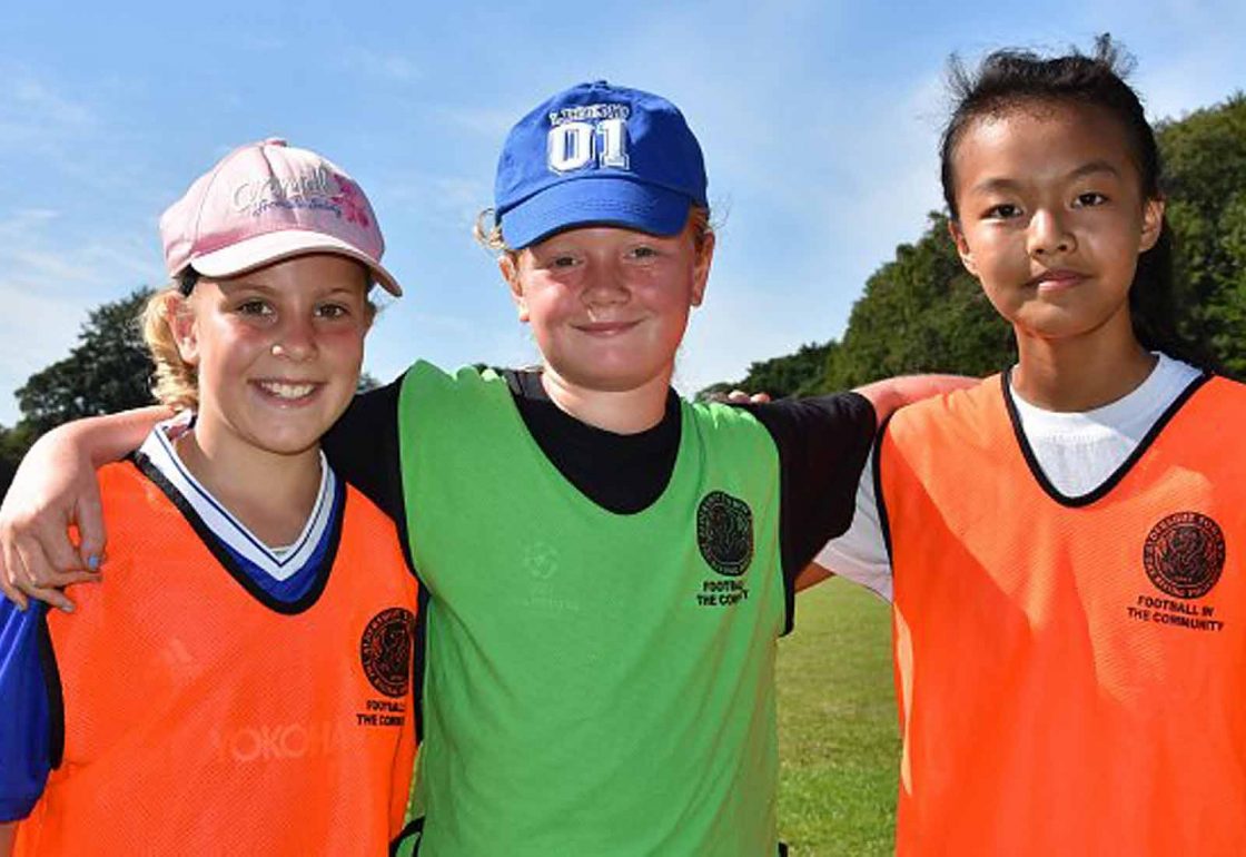 An image of three young children representing Football in the Community an Ellis campbell Foundation grant helping disadvantaged young people in Hampshire, London and Perthshire