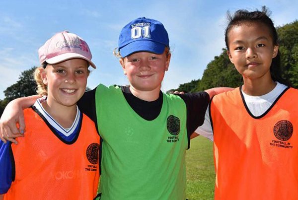 An image of three young children representing Football in the Community an Ellis campbell Foundation grant helping disadvantaged young people in Hampshire, London and Perthshire