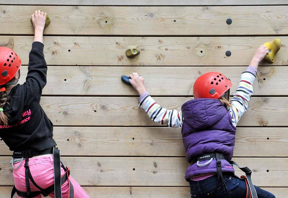 A photo of two young girls using a climbing wall for UK Youth - An Ellis Campbell Foundation charitable grant