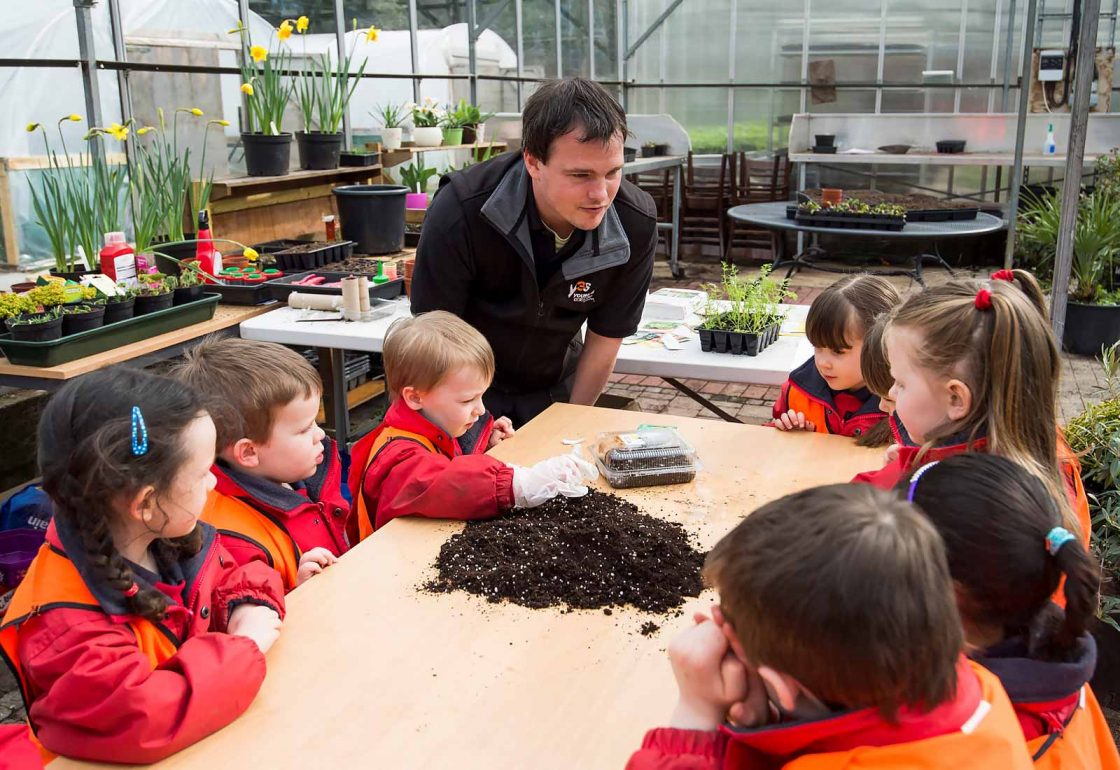 An image of a group of young children sat around a table learning about soil representing Young Enterprise Scotland a grant by the Ellis Campbell Foundation helping disadvantaged young people in Hampshire, London and Perthshire