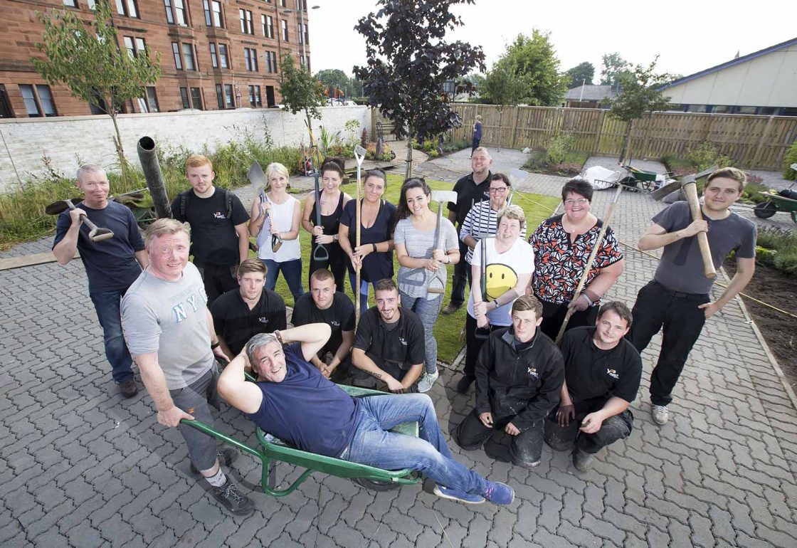 An image of a group of people of mixed ages helping with a gardening project representing Young Enterprise Scotland a grant by the Ellis Campbell Foundation helping disadvantaged young people in Hampshire, London and Perthshire