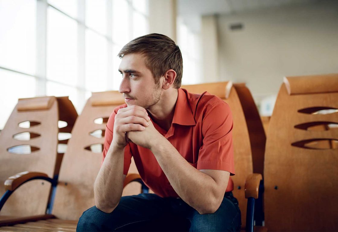 An image of a solitary guy looking pensive representing the MAC UK Mental Health Support Programme Grant made by the Ellis Campbell Foundation helping disadvantaged young people in Hampshire, London and Perthshire