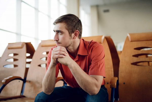 An image of a solitary guy looking pensive representing the MAC UK Mental Health Support Programme Grant made by the Ellis Campbell Foundation helping disadvantaged young people in Hampshire, London and Perthshire