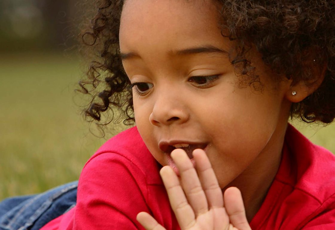 An image of a young girl with her hand to her face lying down representing the School Home Support Grant made by the Ellis Campbell Foundation helping disadvantaged young people in Hampshire, London and Perthshire