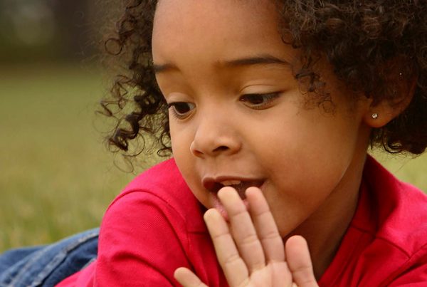 An image of a young girl with her hand to her face lying down representing the School Home Support Grant made by the Ellis Campbell Foundation helping disadvantaged young people in Hampshire, London and Perthshire