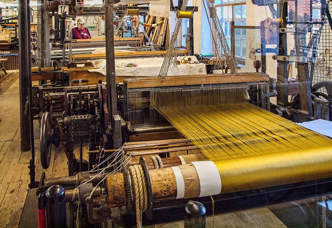 An image of a silk loom with yellow thread representing the Whitchurch Silk Mill Apprenticeship Grant made by the Ellis Campbell Foundation helping disadvantaged young people in Hampshire, London and Perthshire