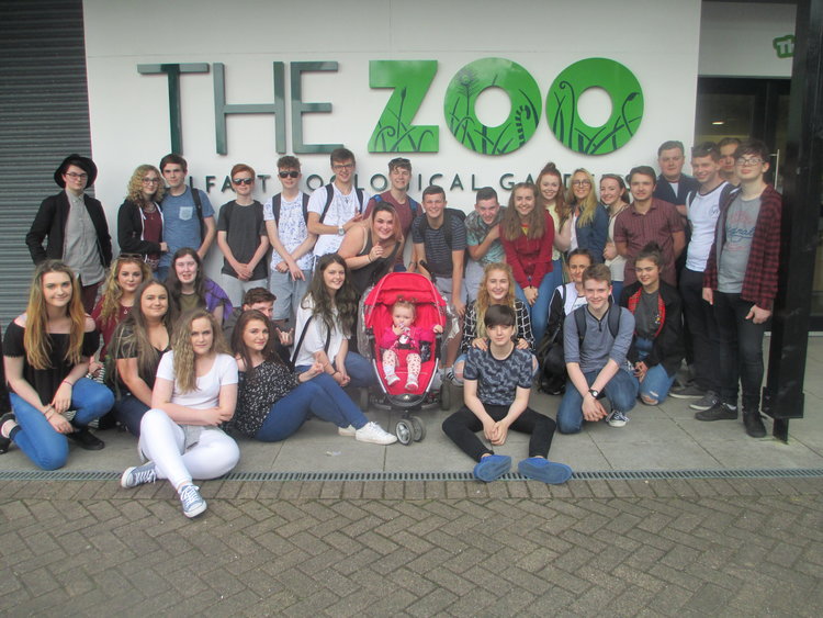A colour image of a group of young people sat outside the zoo - a Hope for Youth NI event supported by The Ellis Campbell Foundation gathering at the Zoo