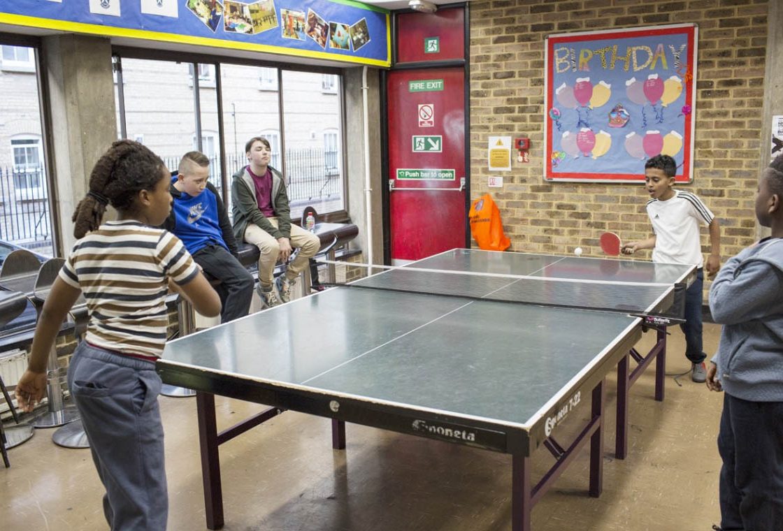 A colour image of young people playing Table Tennis at St Andrews Club Community Based Youth Centre supported by The Ellis Campbell Foundation