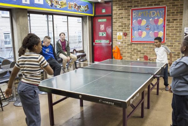 A colour image of young people playing Table Tennis at St Andrews Club Community Based Youth Centre supported by The Ellis Campbell Foundation