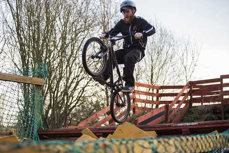A colour image of a male youth on a BMX bike taking part in theTeen Ranch youth Activity Centre supported by The Ellis Campbell Foundation