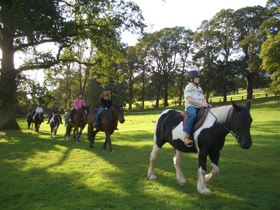 A colour image of a group of children on horseback taking part in theTeen Ranch youth Activity Centre supported by The Ellis Campbell Foundation