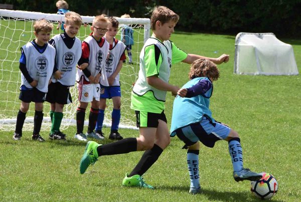 A colour photo of children participating in the Aldershot Town Football in the community programme supported by the Ellis Campbell Foundation Hampshire