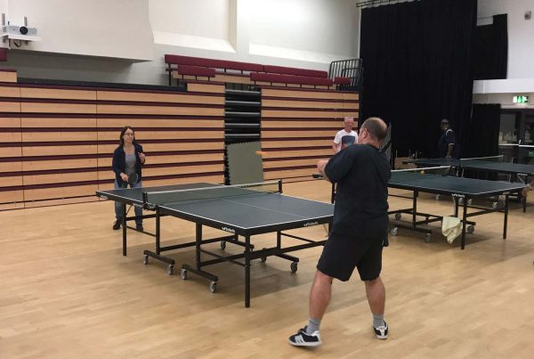 An image of people playing table tennis - Community cohesion by St Katherine's Trust - supported by the Ellis Campbell Foundation