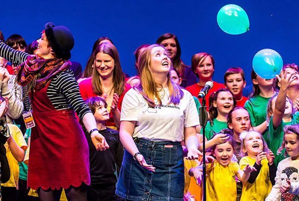 a bright colourful picture showing a group of children performing at the Horsecross Theatre - Perth Autism Youth Theatre supported by The Ellis Campbell Foundation